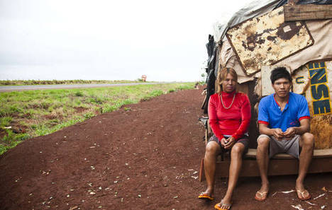 Una pareja guaraní-kaiowá sentada en la parte trasera de su alojamiento rodante, en la comunidad de Apy Ka’y, cerca de Dourados, mato Grosso do Sul, Brasil.